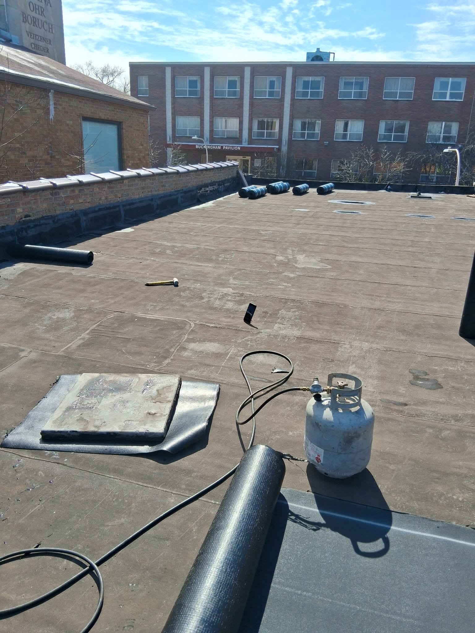 Chicago flat roof before installation — aged surface with visible wear and previous repairs