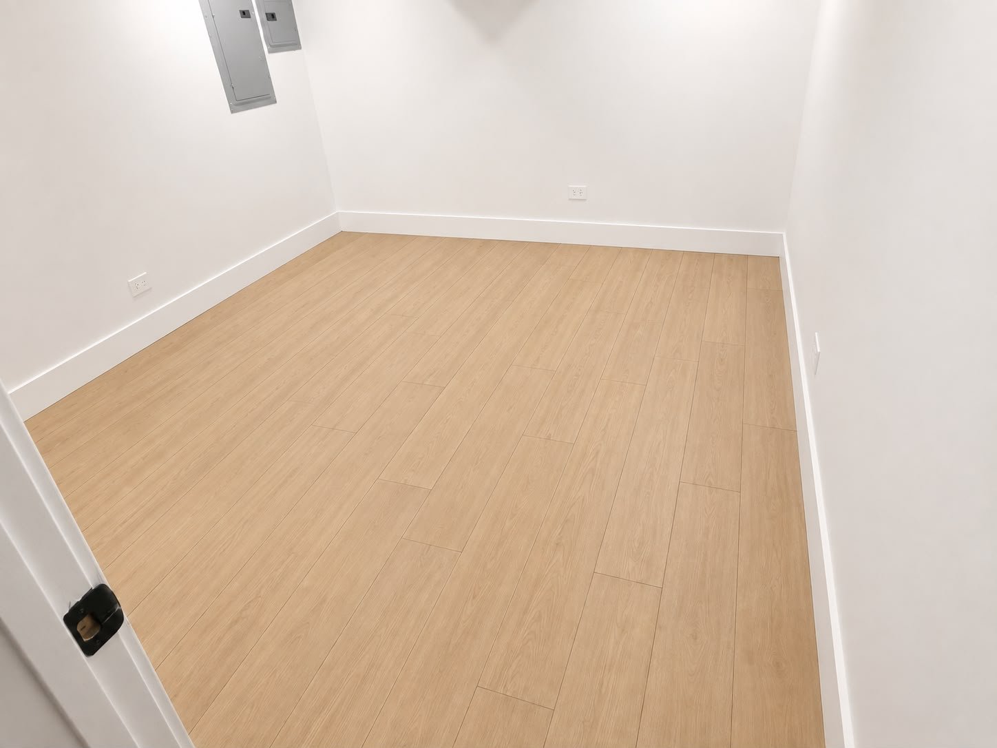 Unfinished basement remodel with wood-look tile flooring Chicago IL